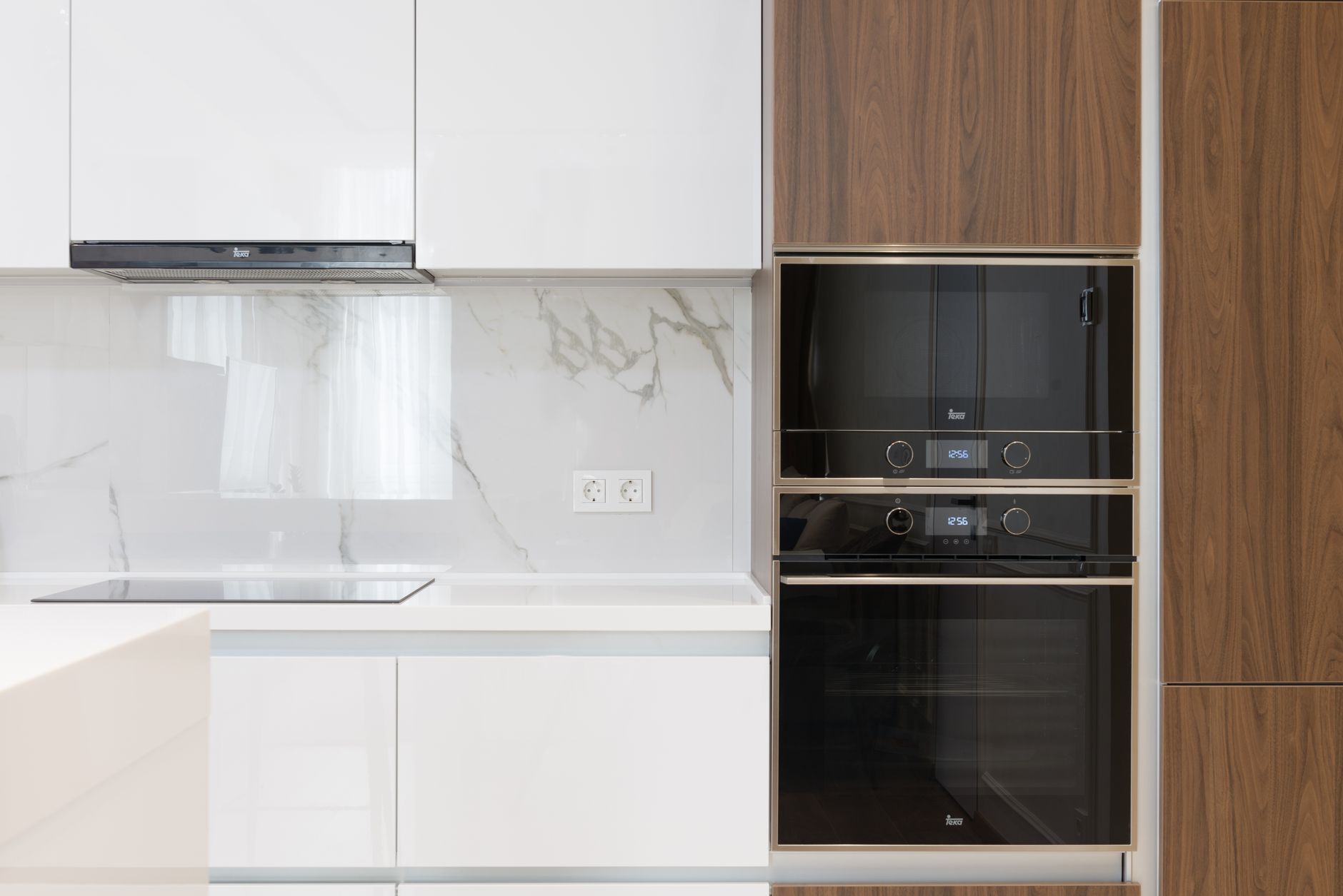 Modern interior of white and wooden kitchen with cabinets cupboards and built in appliances in in Riverside, CA